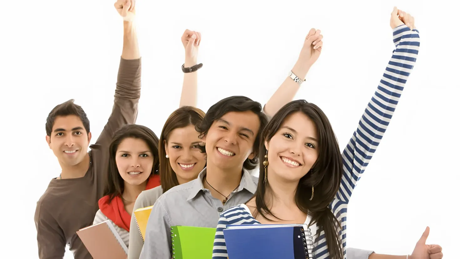 A group of young people with their arms up in the air, smiling and holding books in their hands against a white background.