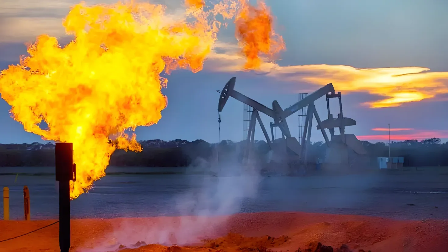 An oil pump in the middle of a field with flames coming out of it, surrounded by poles, water, trees, and a sky with clouds in the background.