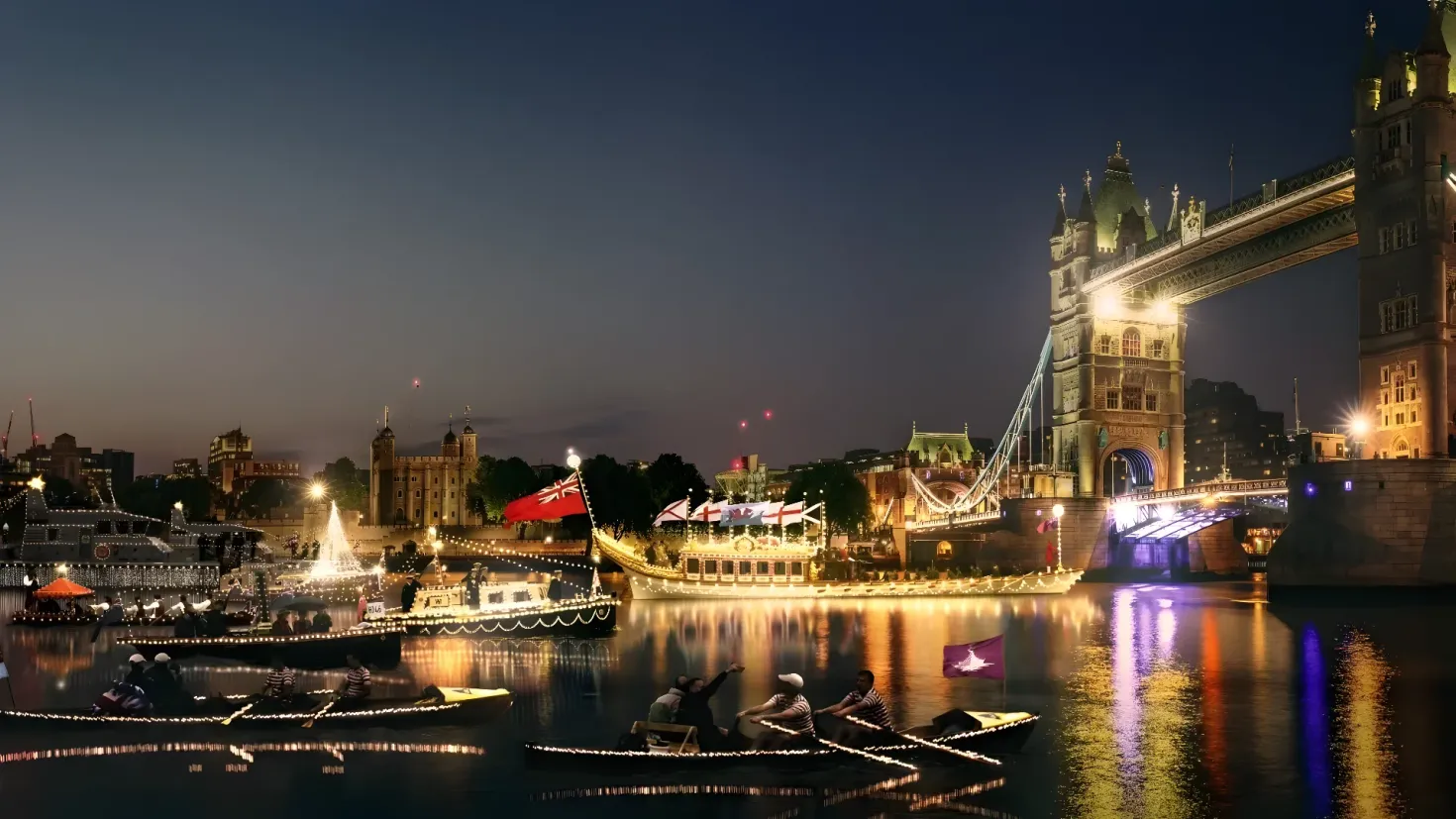 A group of people in a boat on the River Thames at night, illuminated by the lights of the bridge and the stars in the night sky. The boats are filled with people, some of whom are holding paddles, and the river is surrounded by buildings, trees, and a fountain.
