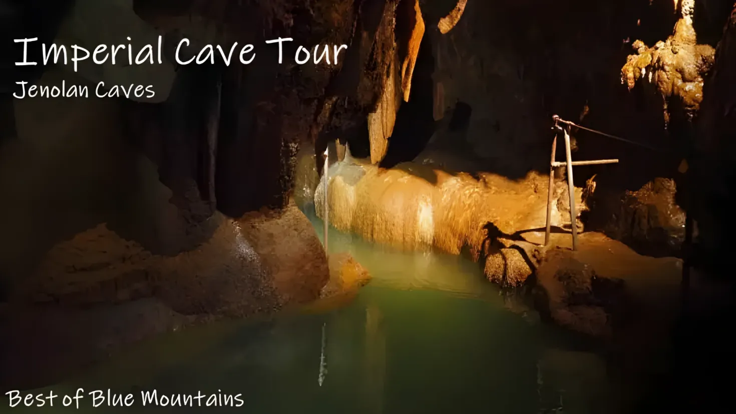 An imperial cave tour in Jenolan Caves, with a body of water at the bottom, rocks on the right side, and text at the top and bottom of the image.