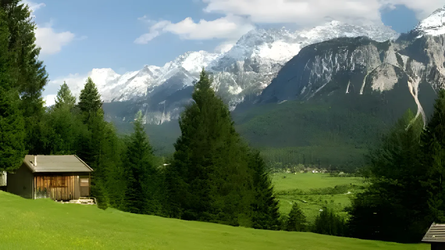 A small cabin nestled in the middle of a lush green field surrounded by trees and hills, with snow-capped mountains in the background and a clear blue sky above.