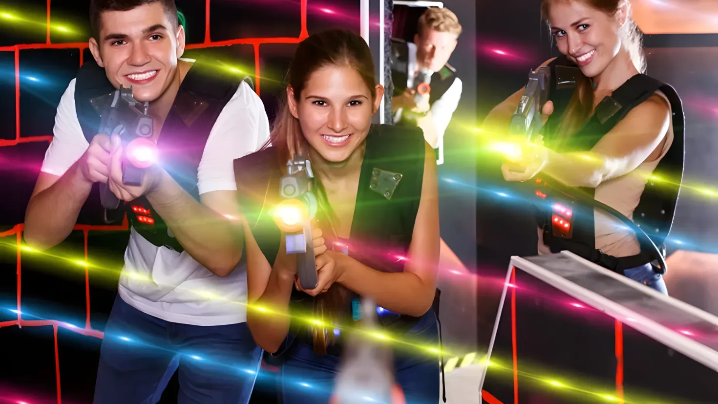 A group of three people standing next to each other, each holding a laser gun in their hands. The background of the image is a wall, suggesting that the group is in a room, and the laser gun they are holding is likely being used for laser tag games.